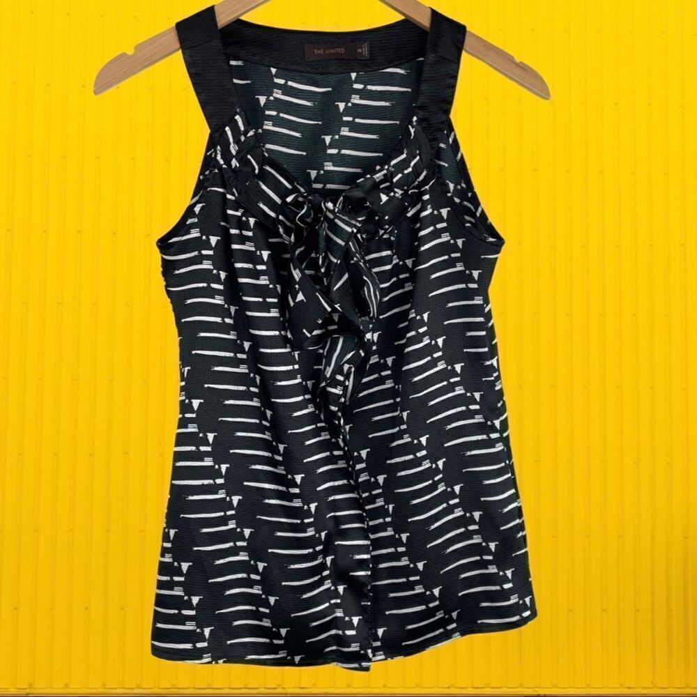 The Limited Sleeveless Black Top with White Patten Design and Ruffle Accents